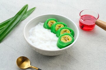Es Pisang Ijo, traditional dessert from Makassar, South Sulawesi, Indonesia, made from banana which is rolled with a mixture of wheat flour, rice flour and coconut milk. Served with pureed and syrup.
