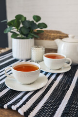 Naklejka na ściany i meble Two cups of tea, tea drinking in Scandinavian cuisine. Beautiful cozy home interior photography