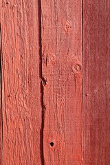 Rough red painted wooden boards vertical background texture