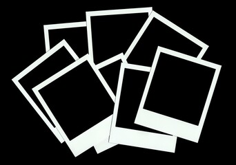Collection of polaroid frames on black background.