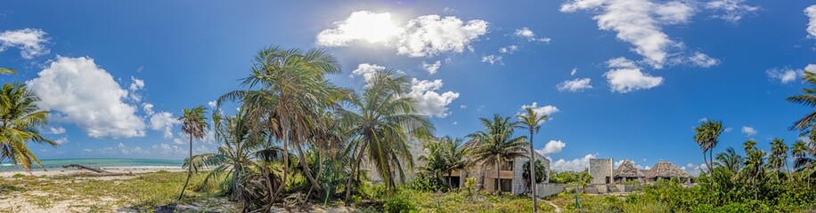 Plakat Picture of a destroyed, overgrown and left to itself hotel complex on a beach