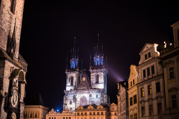 Fototapeta premium gothic church towers on central square from the side of the Charles Bridge of Prague city at night