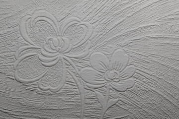 white texture with flowers illustrates white textured material with illustrated flowers on it.