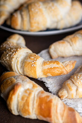 Freshly baked croissants on wooden background. Homemade croissants