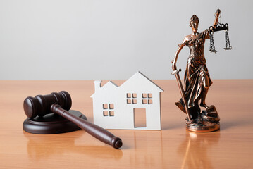 Lady Justice, Judge gavel and house. Concept of real estate auction or dividing house when divorce,...