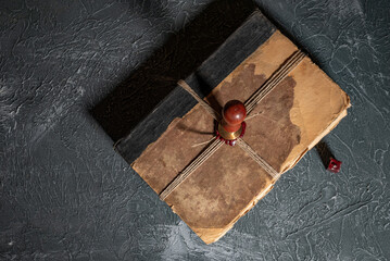 Antique shabby book tied with a thread with a wax seal and a stamp. The concept of secret knowledge