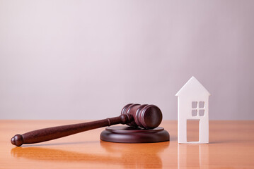 Judge gavel and house. Concept of real estate auction or dividing house when divorce, division of...