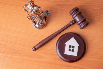 Lady Justice, Judge gavel and house. Concept of real estate auction or dividing house when divorce,...