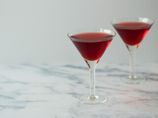 Red alcoholic drinks on light grey background. Campari coctail.