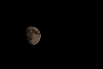 Close up of new moon with visible craters on its surface on black night sky background with copy space