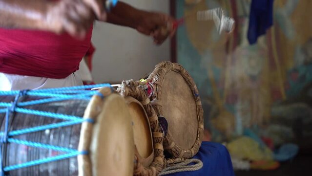 Dark-skinned person makes beautiful music on a Yak Beraya which is a typical drum instrument from Sri Lanka. Close up shot