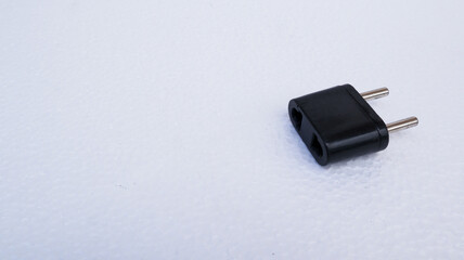 european plug converter in black on white background. us to eu converter adapter.