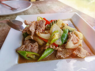 Thai stir fried pork with hot pepper in white plate