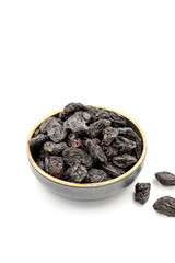 Black dried raisins on a white background. healthy and fresh.nuts. Close-up.