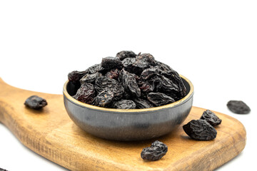Black dried raisins on a white background. healthy and fresh.nuts. Close-up.
