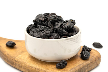 Black dried raisins on a white background. healthy and fresh.nuts. Close-up.