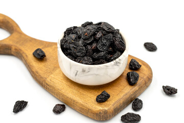 Black dried raisins on a white background. healthy and fresh.nuts. Close-up.