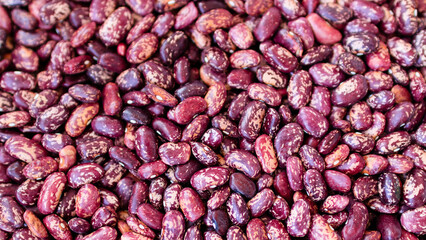 Red and white organic beans background. Raw red organic kidney beans close up. Healthy food, vegetarian.
