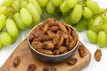 Dried raisins on a white background. Raw grapes and raisins. Healthy and fresh nuts. close-up. Local name besni uzum