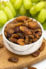 Dried raisins on a white background. Raw grapes and raisins. Healthy and fresh nuts. close-up. Local name besni uzum