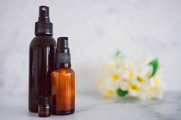 natural beauty and organic ingredients in skincare, apothecary skincare bottles with tropical flowers bokeh