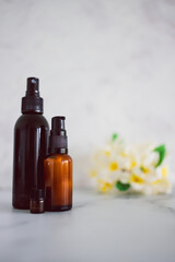 natural beauty and organic ingredients in skincare, apothecary skincare bottles with tropical flowers bokeh