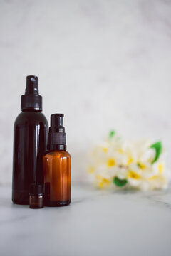 natural beauty and organic ingredients in skincare, apothecary skincare bottles with tropical flowers bokeh