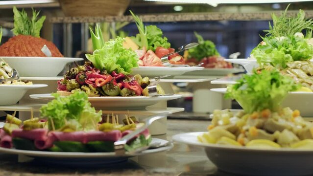 There are olive oil dishes and vegetables at the open buffet. 4k. slow motion.cold appetizer buffet.motion camera