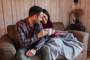 Fototapeta premium Smiling people, drinking coffee, and sitting next to each other, enjoying indoors.