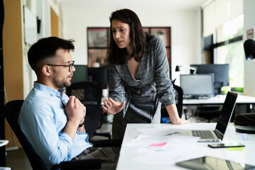 Colleagues arguing in office. Angry businesswoman yelling at her collegue