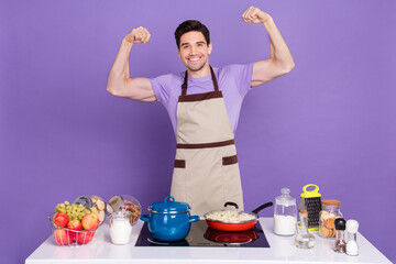 Photo of strong funky boyfriend dressed chef outfit showing arms muscles isolated purple color...