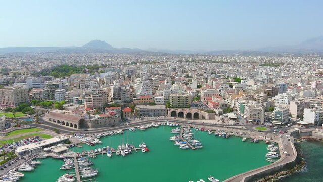 Heraklion, Greece: Aerial view of capital city of Greek island of Crete, Rocca a Mare Fortress, clear waters of Mediterranean Sea, yachts and ships in city marina - landscape panorama of Europe from a