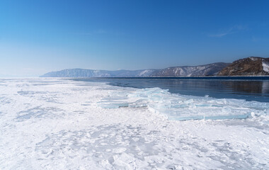 Winter landscape with mountains and Lake Baikal in Siberia on sunny day. Natural background.