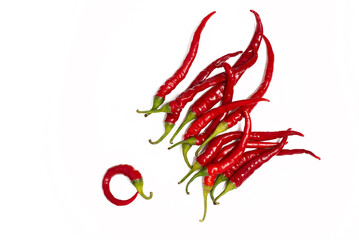 a lot of hot red pepper lies on a white background