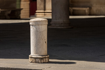 Close-up of a marble bollard, part of the ancient Loggia Palace (Palazzo della Loggia) in Renaissance Style, Loggia town square (Piazza della Loggia). Lombardy, Italy, Southern Europe.