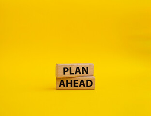 Plan ahead symbol. Wooden blocks with words 'Plan ahead'. Beautiful yellow background. Business and 'Plan ahead' concept. Copy space.