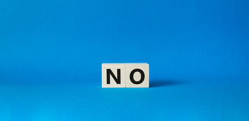 No symbol. Concept words No on wooden blocks. Beautiful blue background. Business and No concept. Copy space.