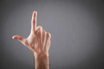 Male hand making Loser gesture. Space for your text