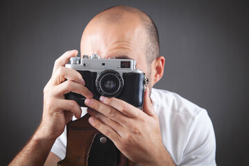  Man taking a picture with old camera.