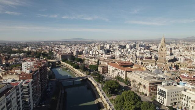 Aerial panorama of Murcia City, Segura riverbank, panning shot revealing Murcia Cathedral. Spain