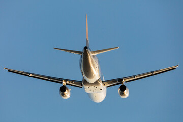 Commercial Airliner aircraft flying against a clear blue sky. 