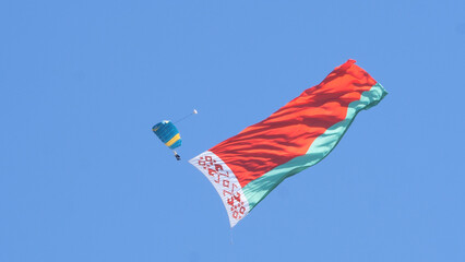 paratroopers in the sky with the Belarusian flag on the May 9 Victory Day in Mogilev, Belarus