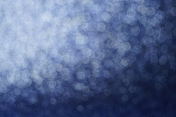 Blurred shiny blue background with silver round bubbles