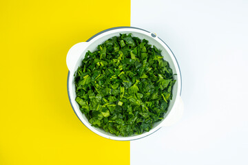 Lots of chopped spinach in white case, cooking and vegetable idea, healthy lifestyle, vegan life,...