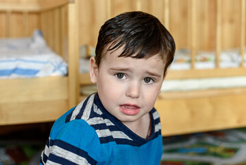 Portrait of a small baby boy 3 years old in the nursery