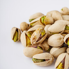 fresh salted pistachios on a white background