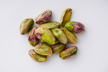 fresh salted pistachios on a white background