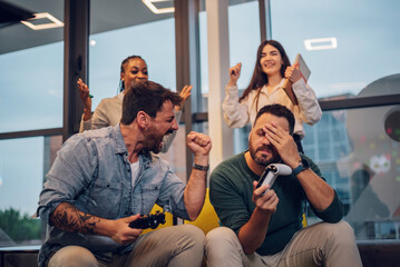 Work colleagues playing video games during their work break