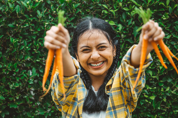 eating vegan vegetable for healthy good for life concept. young teen hand holding baby carrot happy smile.