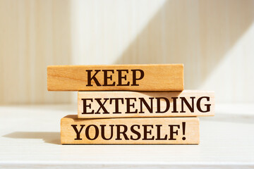 Wooden blocks with words 'Keep Extending Yourself'.